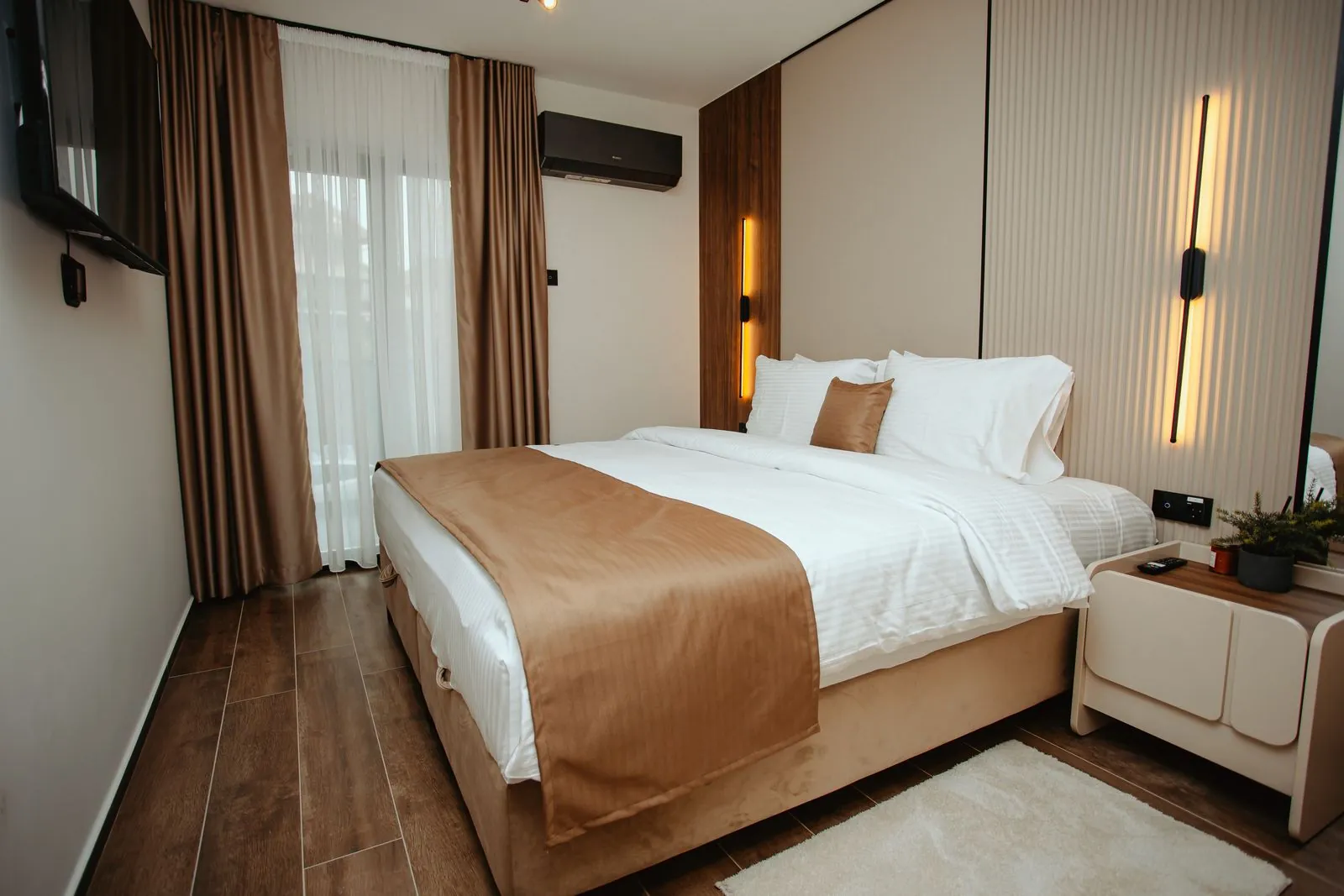 Apartment bedroom with a double bed and wood panelling