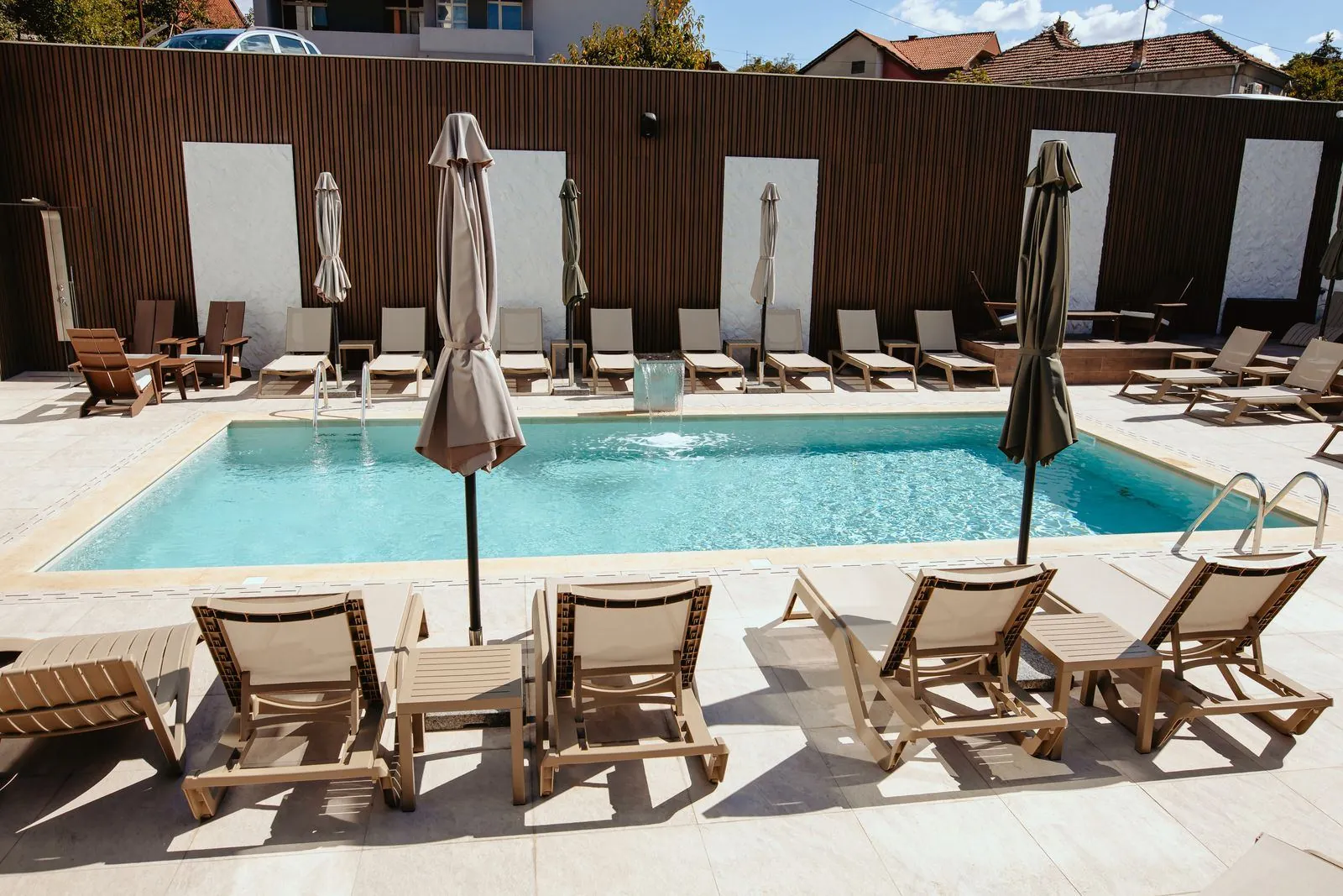 The hotel outdoor pool with sun loungers and umbrellas