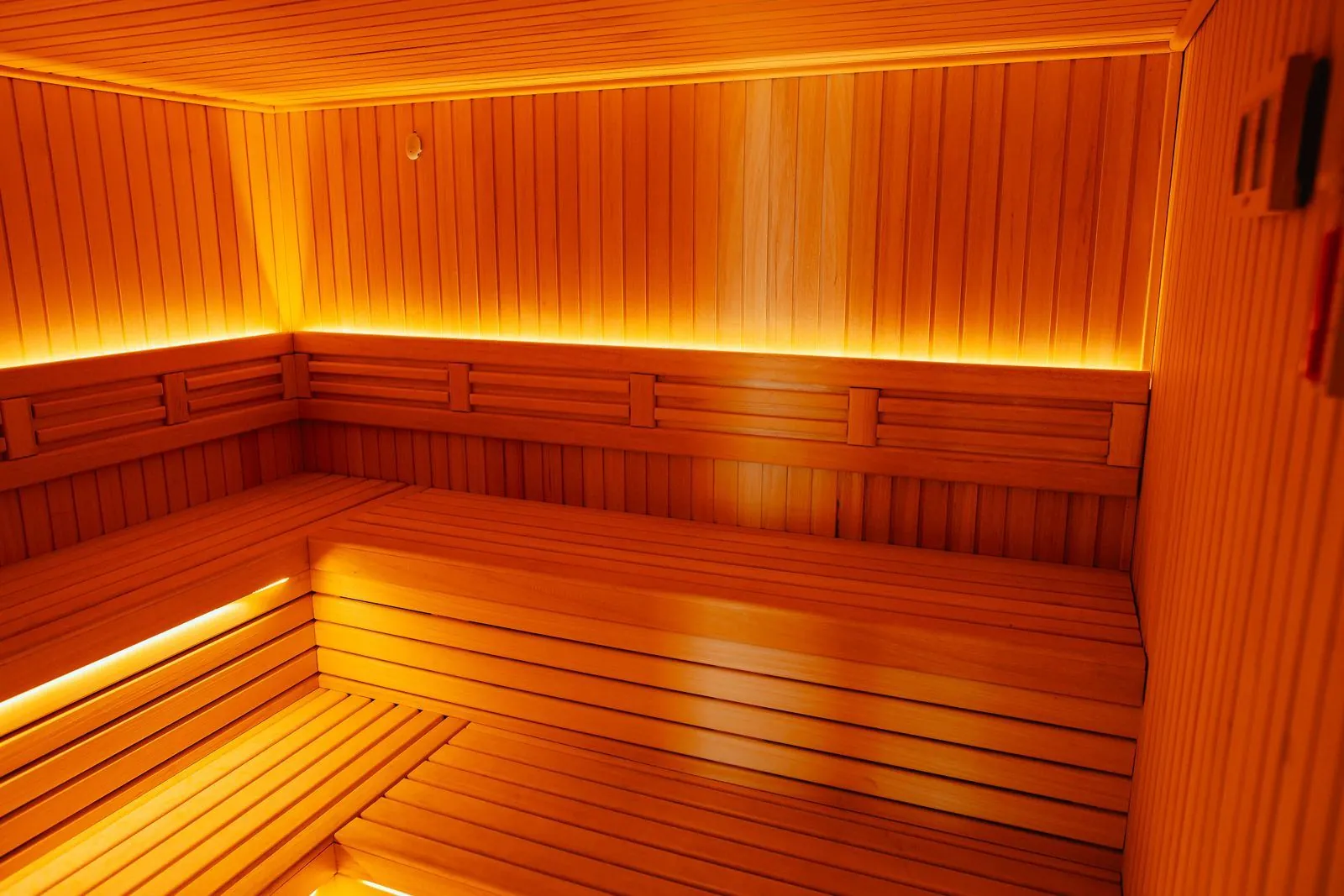 Sauna with wooden benches and warm light