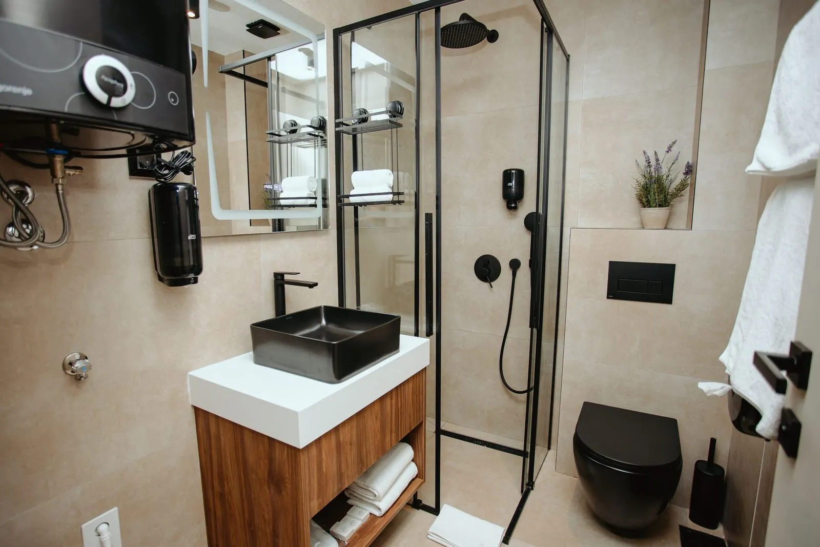 Bathroom with shower, washbasin and towels