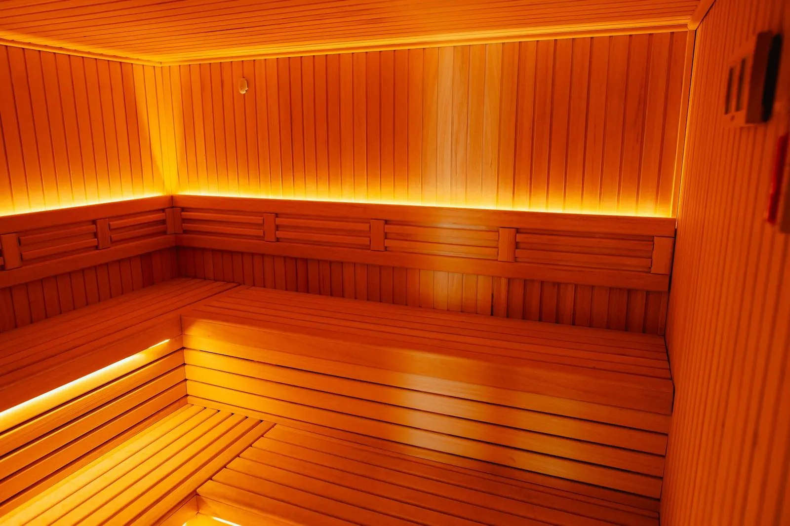 Sauna with wooden benches and warm light