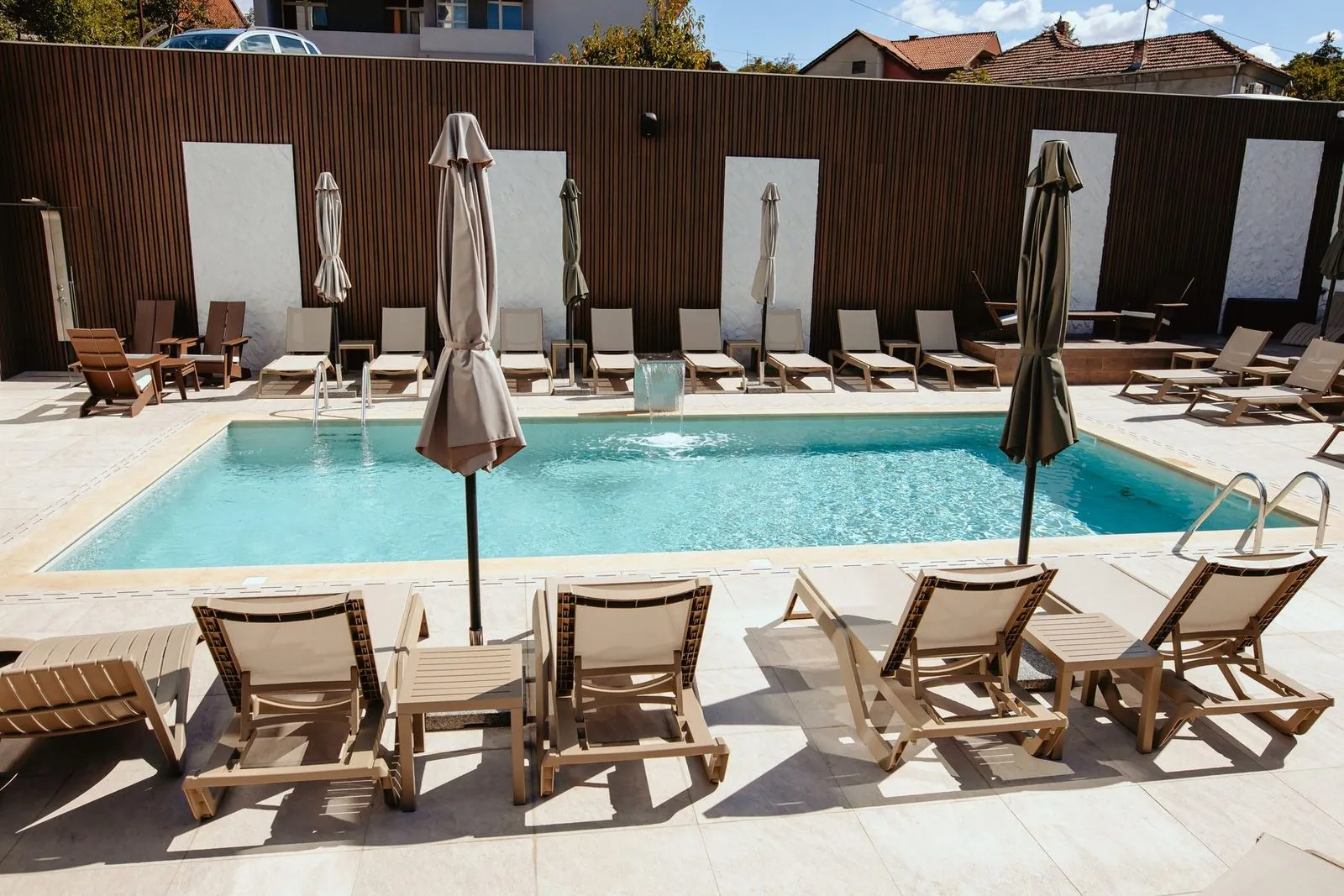 Pool with sun loungers and umbrellas