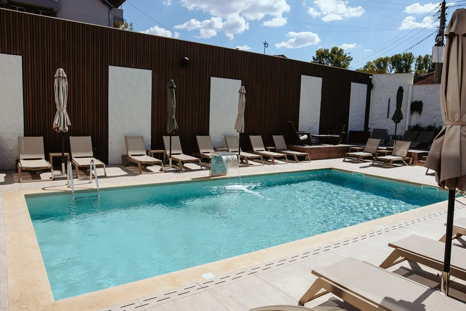 Pool and terrace by the wooden fence