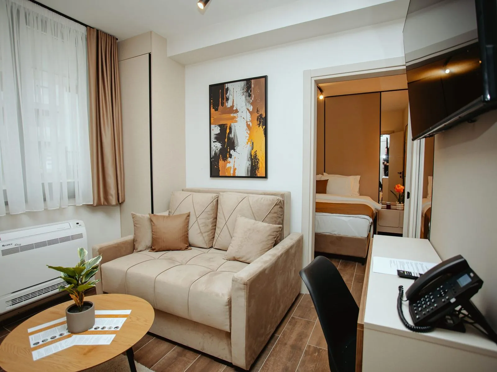 Superior studio with a sofa and the double bed in the background