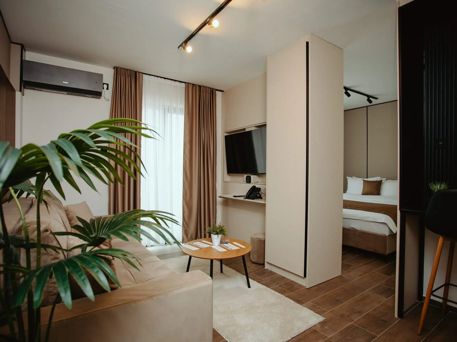 Studio apartment with a living area and the bed behind a partition