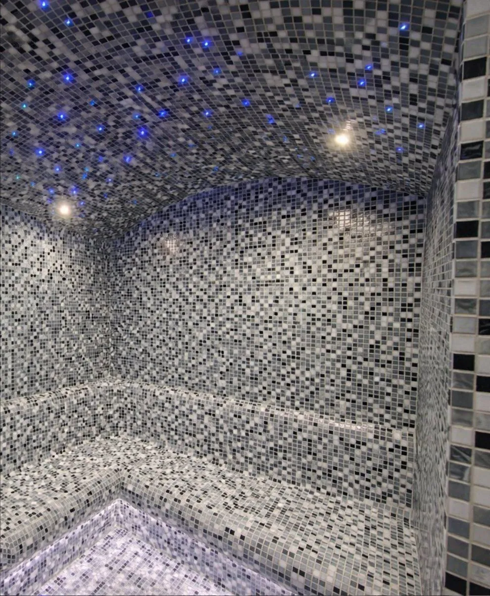Steam room with mosaic tiles and ceiling lights