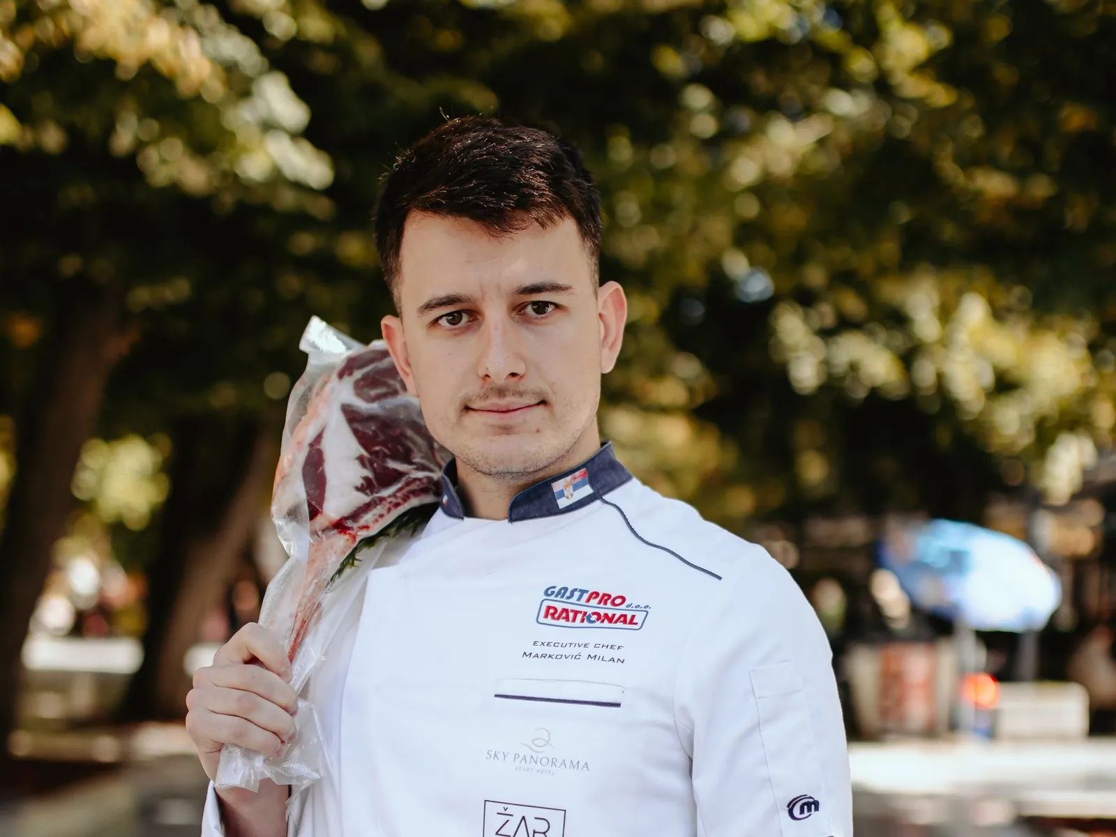 Executive chef Milan Marković with a tomahawk steak on his shoulder