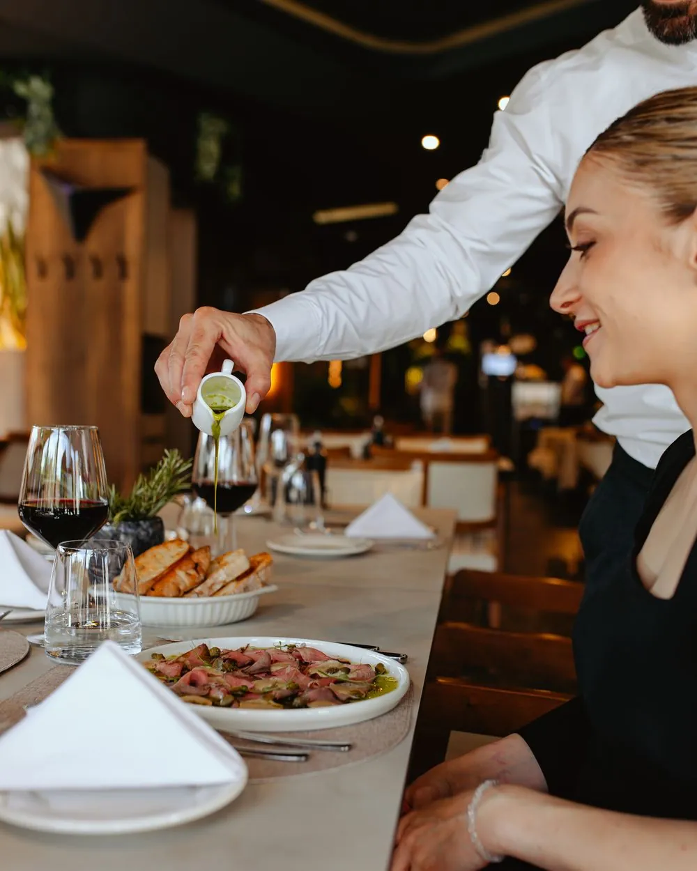 Waitress serving a guest at the table