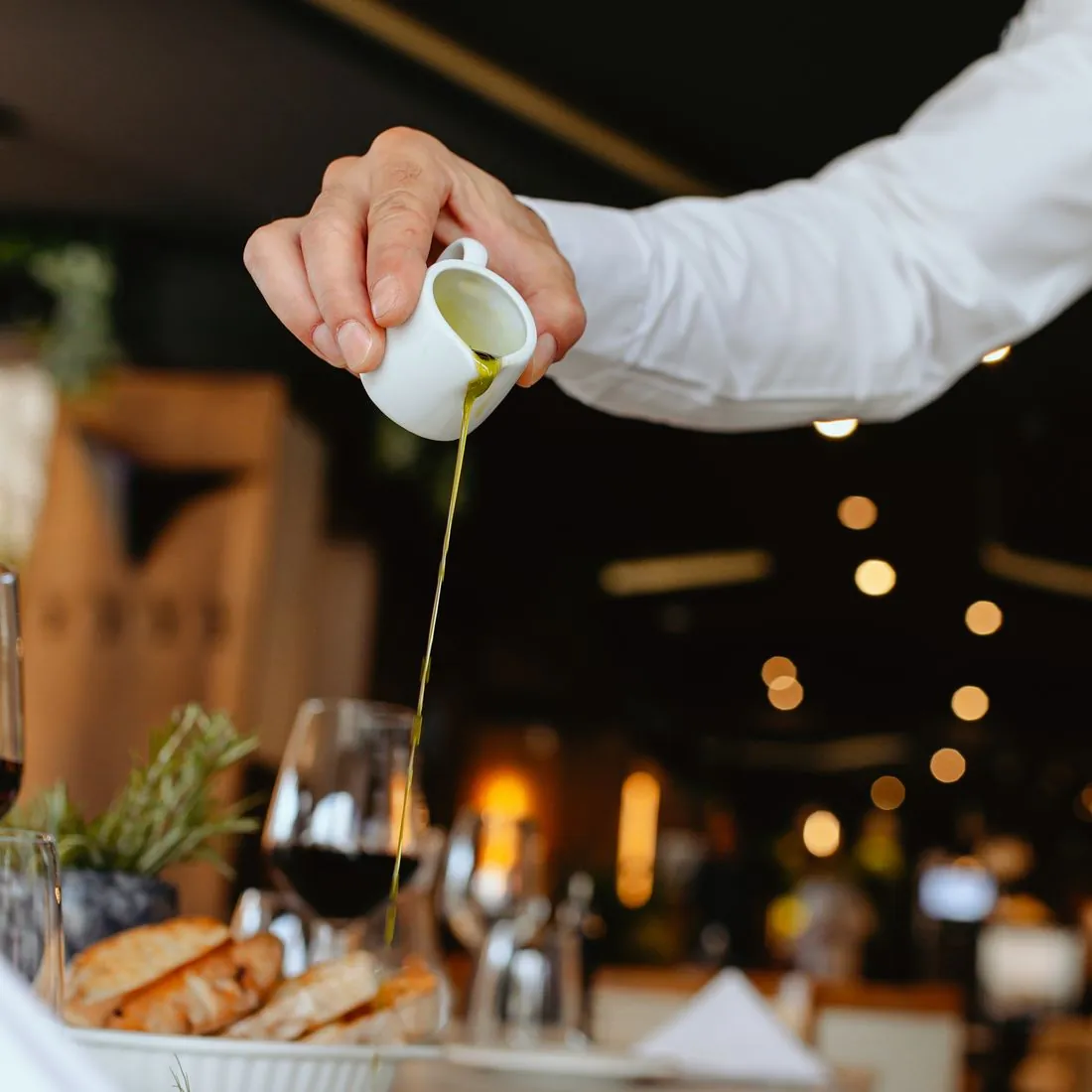 Sauce poured from a ceramic jug over a dish