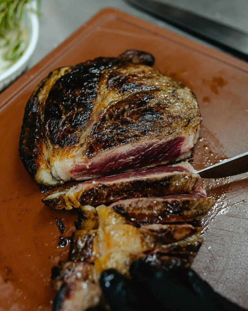 Sliced steak on a wooden board